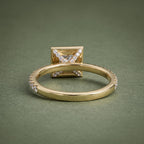Back perspective view displaying the inner polished band and diamond-set basket support structure.