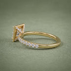 Close-up side view highlighting the micro-pavé diamond bridge work beneath the yellow gold halo setting.
