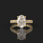 Front top-down view of a 3 CT oval lab grown diamond solitaire ring on a yellow gold pavé band.