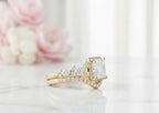 Side profile perspective showing the halo setting, floral side clusters, and nested curved pavé band in yellow gold.