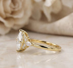Side profile view of a 3 CT kite-set princess cut lab grown diamond ring with floral side clusters in yellow gold.