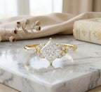 Yellow gold 3 CT kite-set princess cut lab grown diamond engagement ring with floral cluster accents.