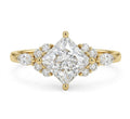 Top-down studio shot of a 3 carat kite-oriented princess cut lab diamond ring with marquise and round side clusters.