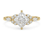Top-down studio shot of a 3 carat kite-oriented princess cut lab diamond ring with marquise and round side clusters.