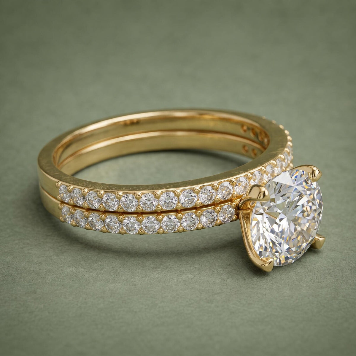 3 CT round cut lab grown diamond solitaire engagement ring stacked with matching pavé band in yellow gold.