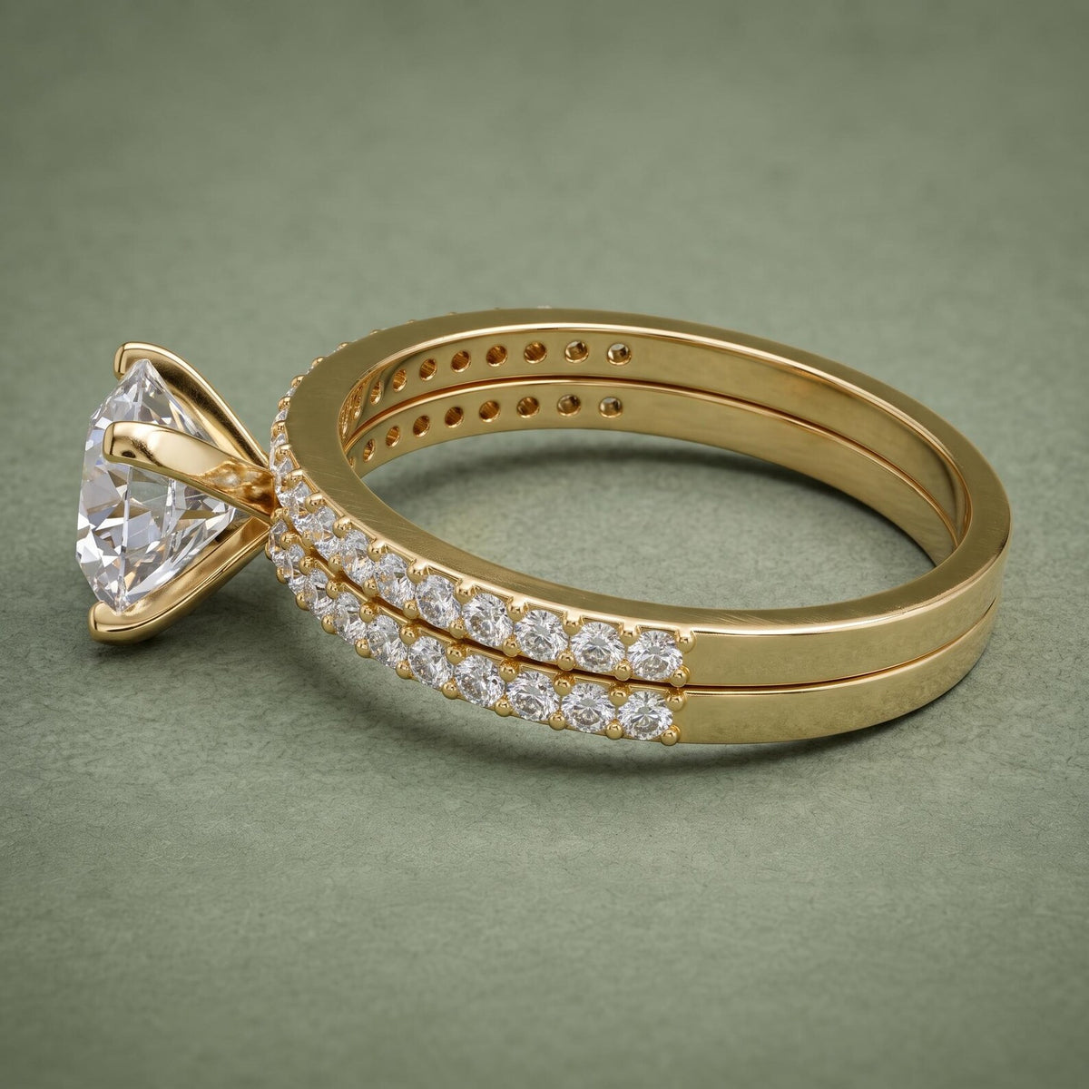 Side view of yellow gold band shanks on a 3 carat round lab grown diamond stacked ring set.