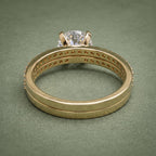 Interior band gallery and basket structure of 3 carat round lab diamond yellow gold bridal set.