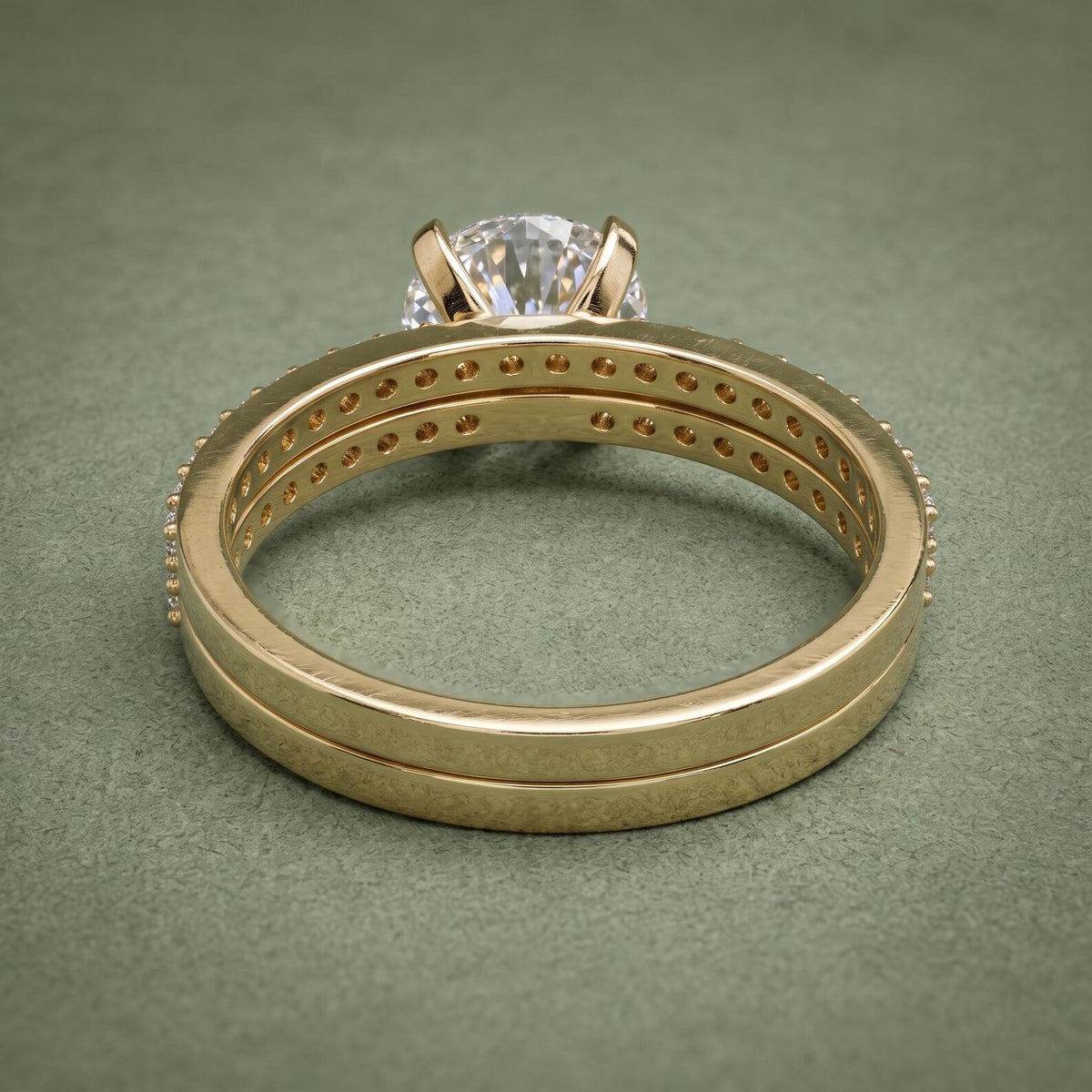 Interior band gallery and basket structure of 3 carat round lab diamond yellow gold bridal set.