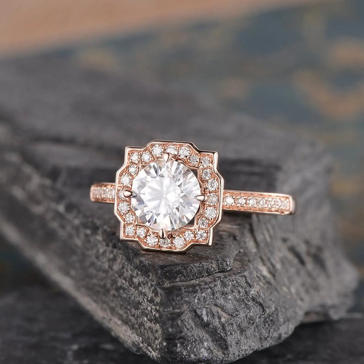 2 CT round cut lab grown diamond engagement ring with a geometric scalloped halo in rose gold on a dark stone background.