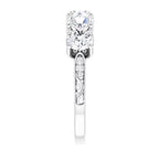 Side elevation view highlighting the hand-engraved scroll accents on the shank of a white gold 5-stone diamond ring.
