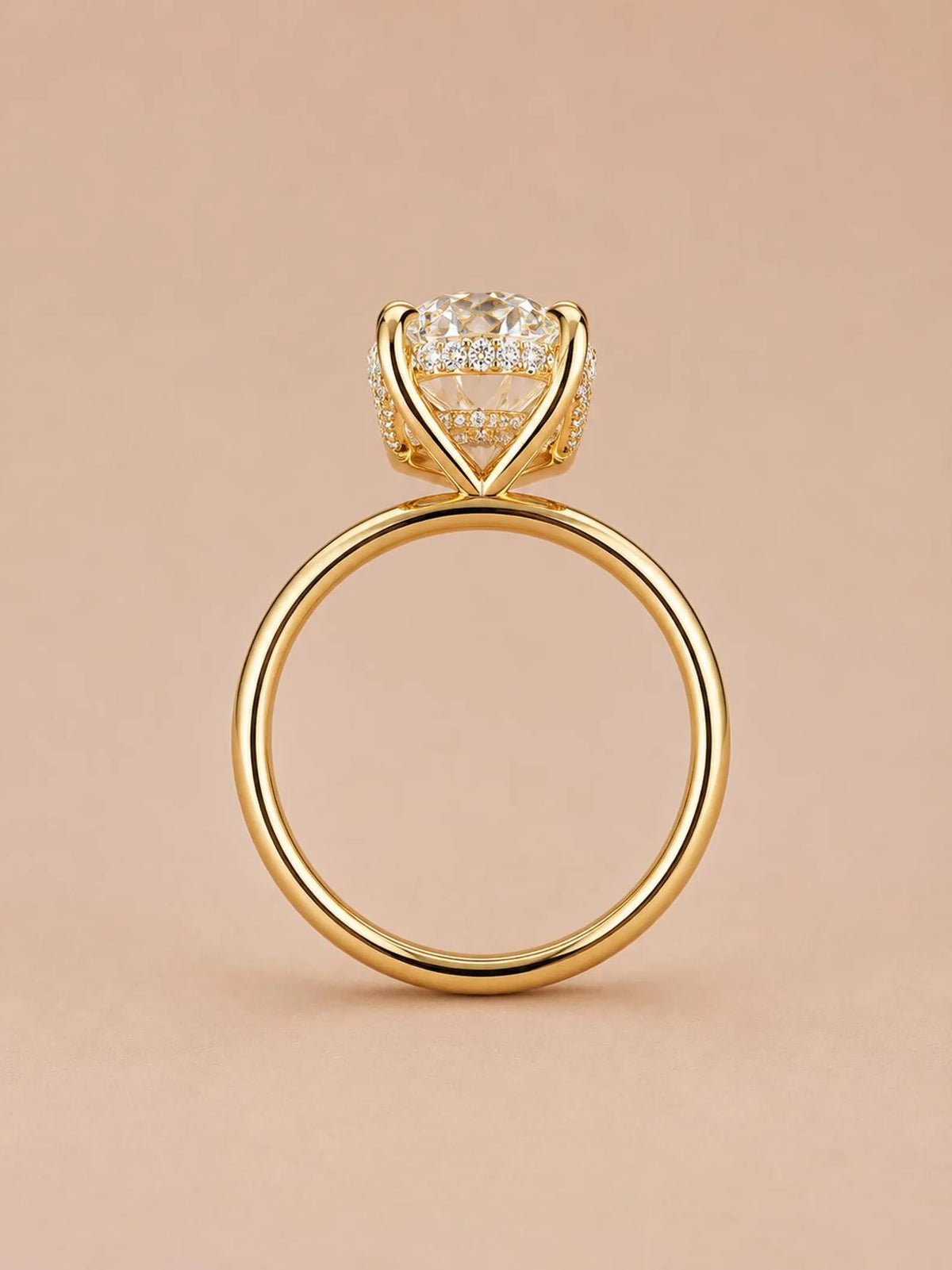 Side profile of a 4 CT oval lab grown diamond ring in 18K yellow gold showing hidden halo gallery detail.