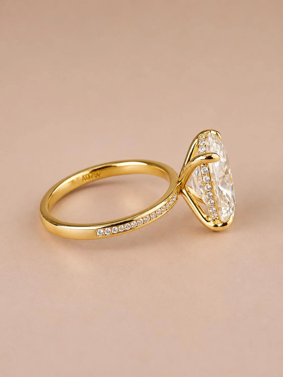 Side angle view of 4 CT oval cut lab grown diamond ring set in 18K yellow gold.