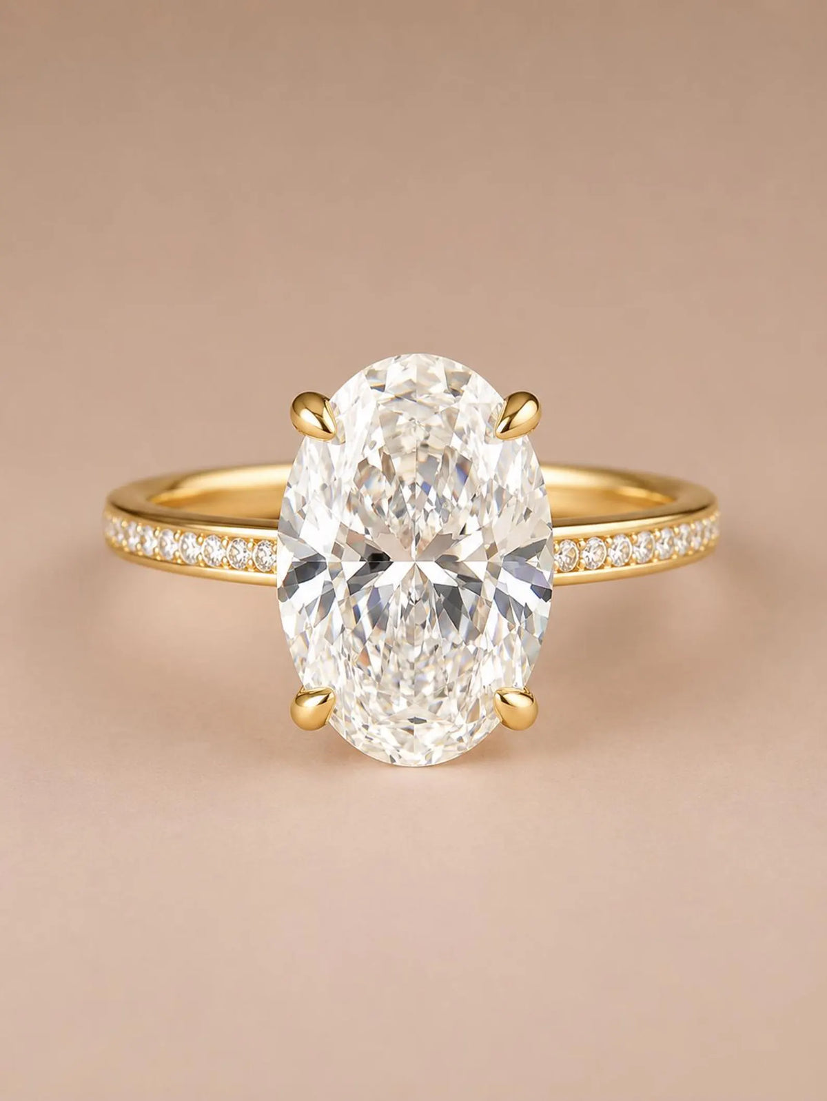 Direct front view of a 4 CT oval cut lab grown diamond with claw prongs on a yellow gold pavé band.