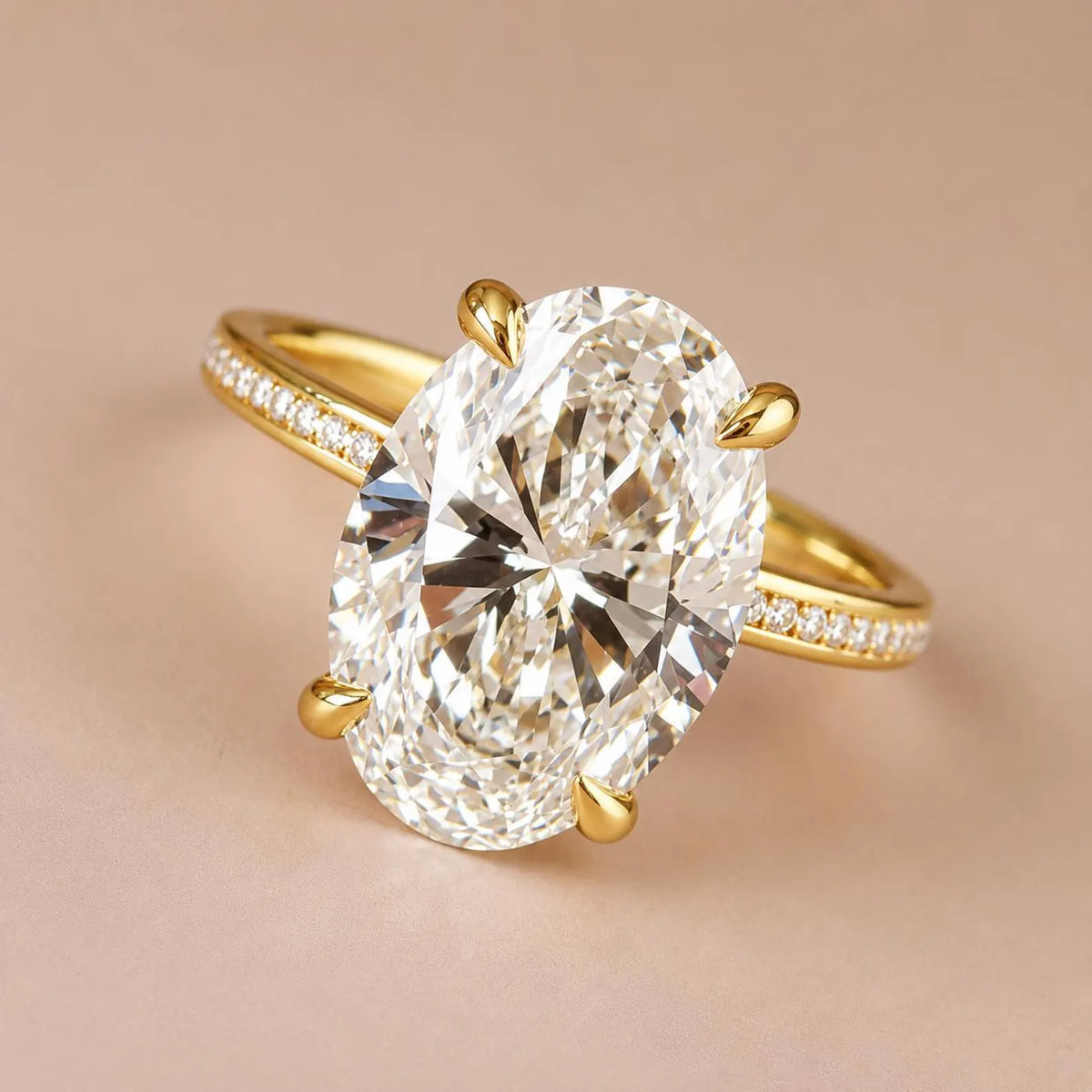 Close-up top perspective view of a massive 4 carat oval lab grown diamond in a yellow gold setting.