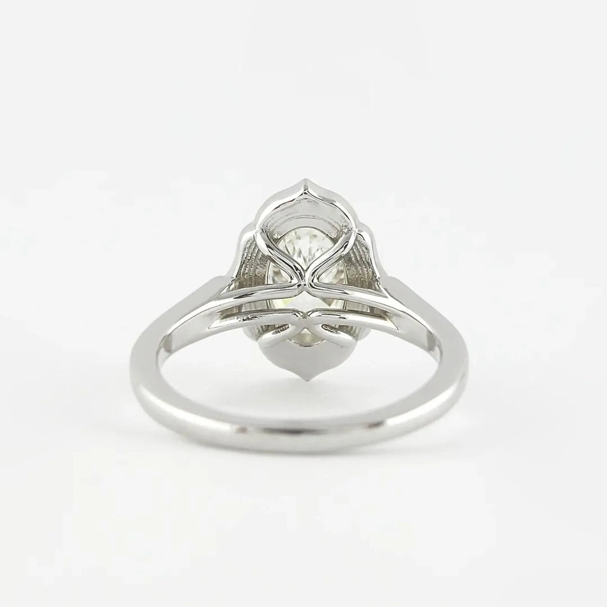 Underside gallery view of a white gold 3 CT oval lab diamond ring featuring delicate bridge architecture.