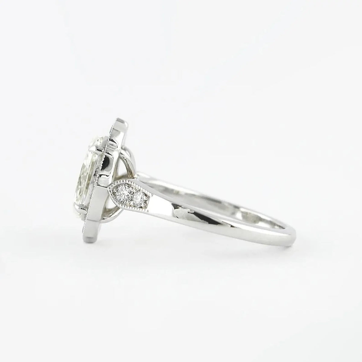Profile side view highlighting milgrain shoulder accents on a 3 CT oval lab diamond ring.