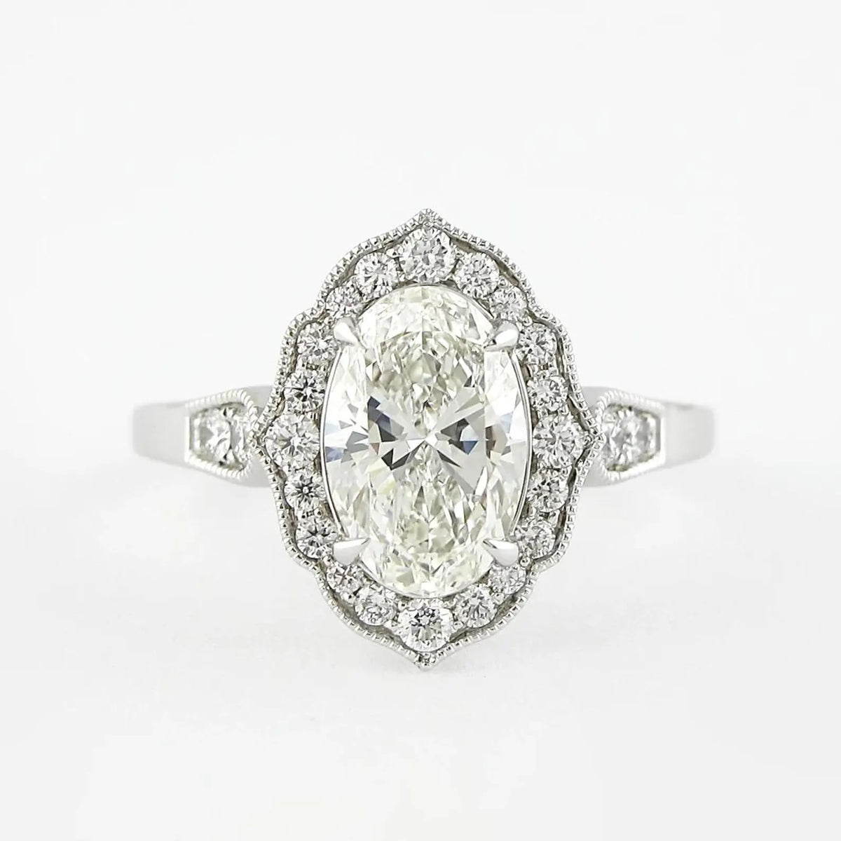 Top-down view of a 3 CT oval cut lab grown diamond in an Art Deco scalloped halo setting.