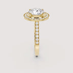 Side profile view of a 4 CT round lab grown diamond halo ring with pave band in yellow gold.