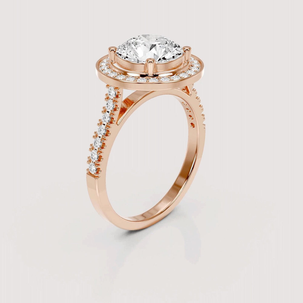 A rose gold engagement ring featuring a large round-cut diamond center stone, a halo of small diamonds, and a pavé diamond shank, shown on a light gray background.