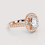 Rose gold halo ring with a large oval center stone and pavé-set accent stones on the band, shown on a light gray background.