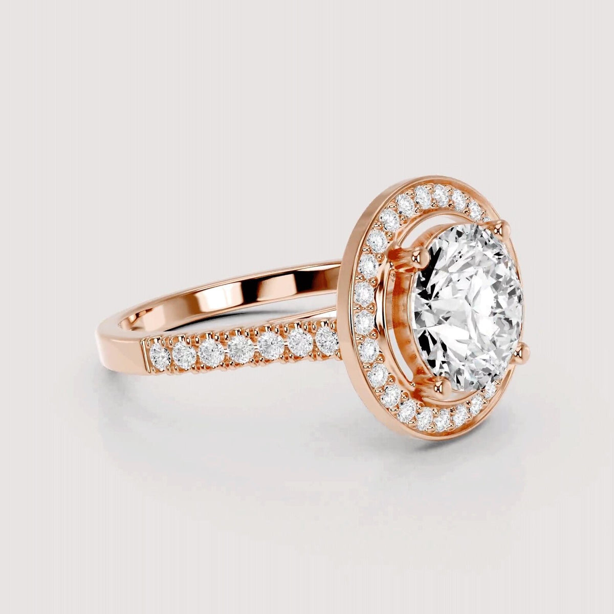 Rose gold halo ring with a large oval center stone and pavé-set accent stones on the band, shown on a light gray background.