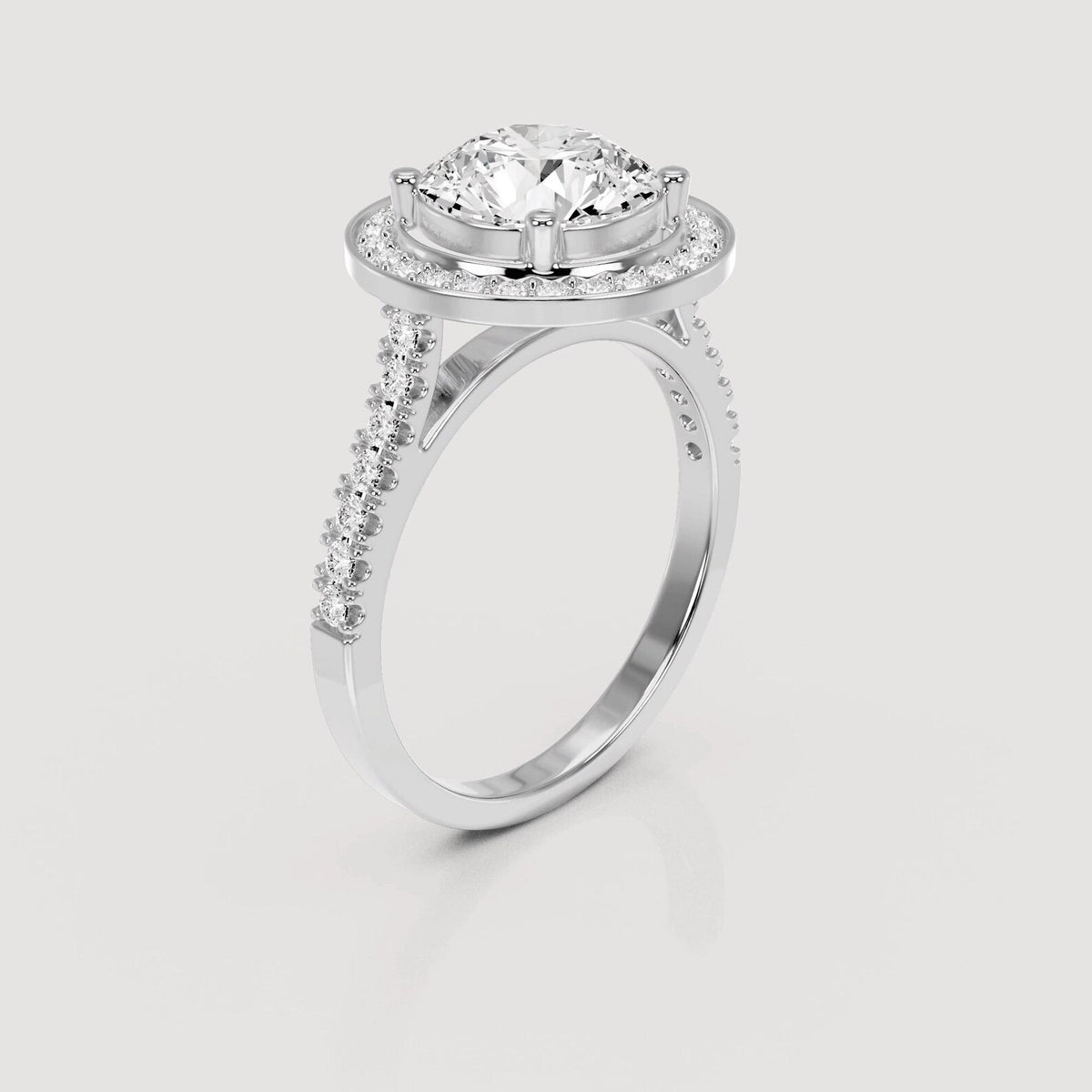 Angled side view showing cathedral band of 4 CT round lab diamond halo ring in white gold.