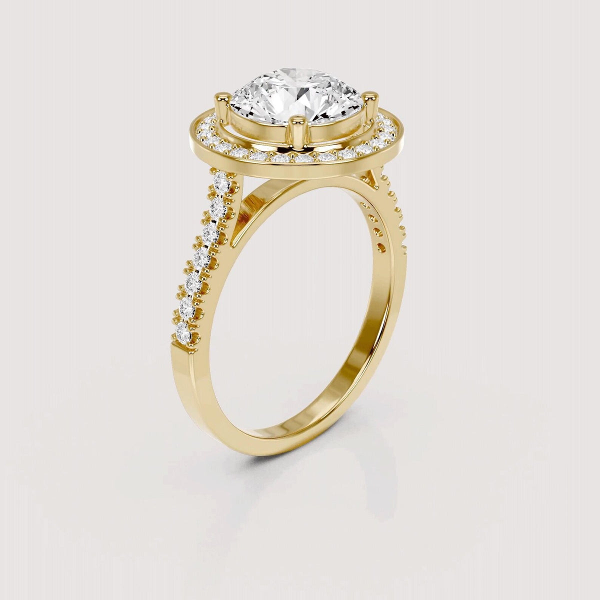 Angled profile view of a 4 CT round lab grown diamond halo engagement ring in yellow gold.