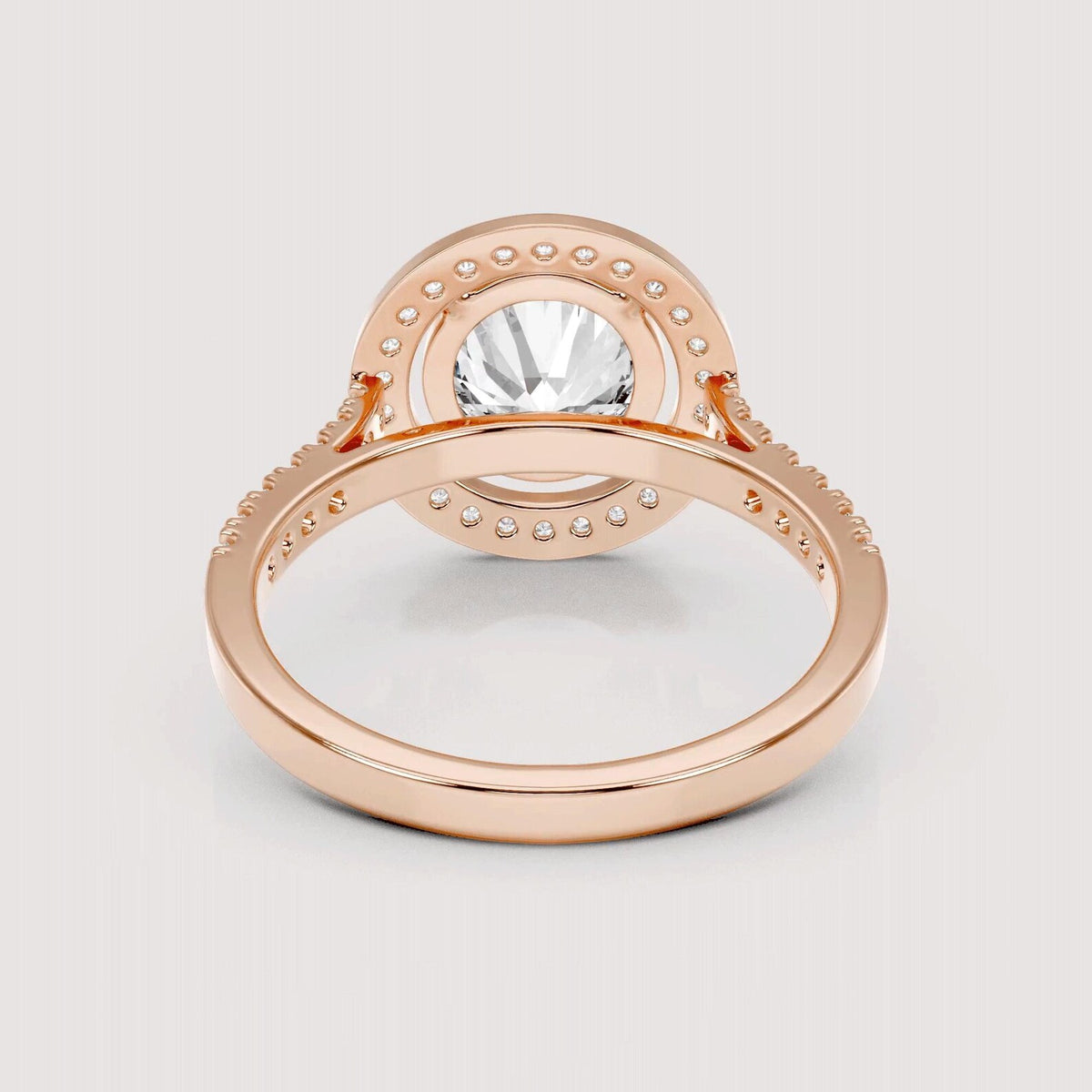 Under-gallery perspective of a 4 CT round cut lab grown diamond halo ring in rose gold.