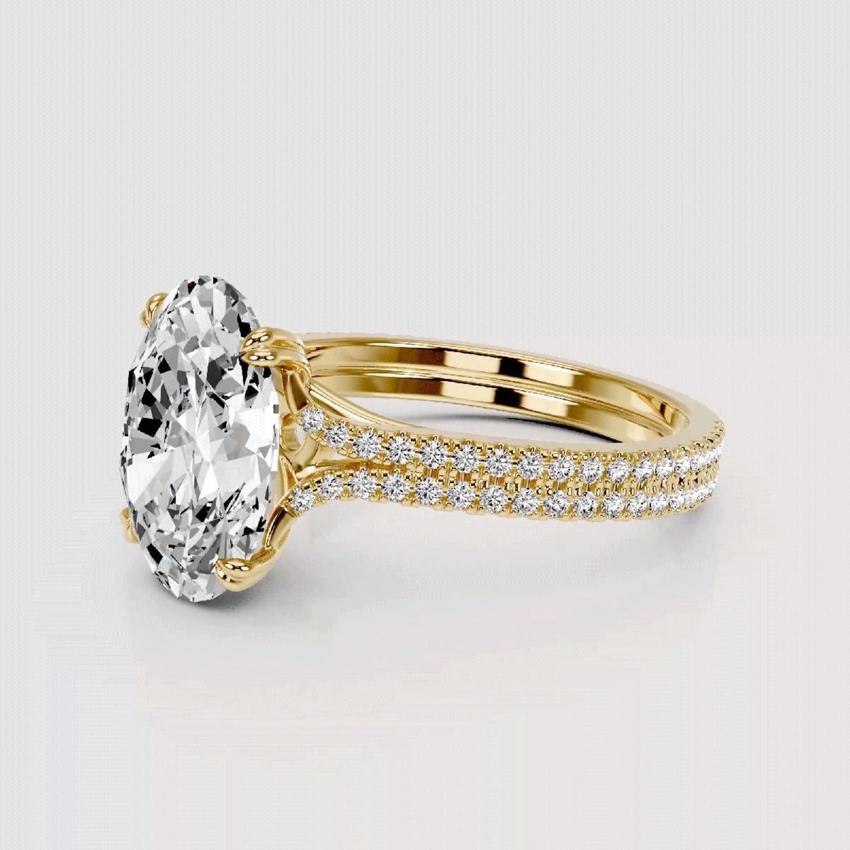 Gold ring with a large diamond and smaller diamonds on the band against a light gray background