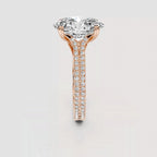 A rose gold solitaire engagement ring featuring a large round brilliant-cut diamond center stone and a pavé-set diamond shank, shown on a light gray background.