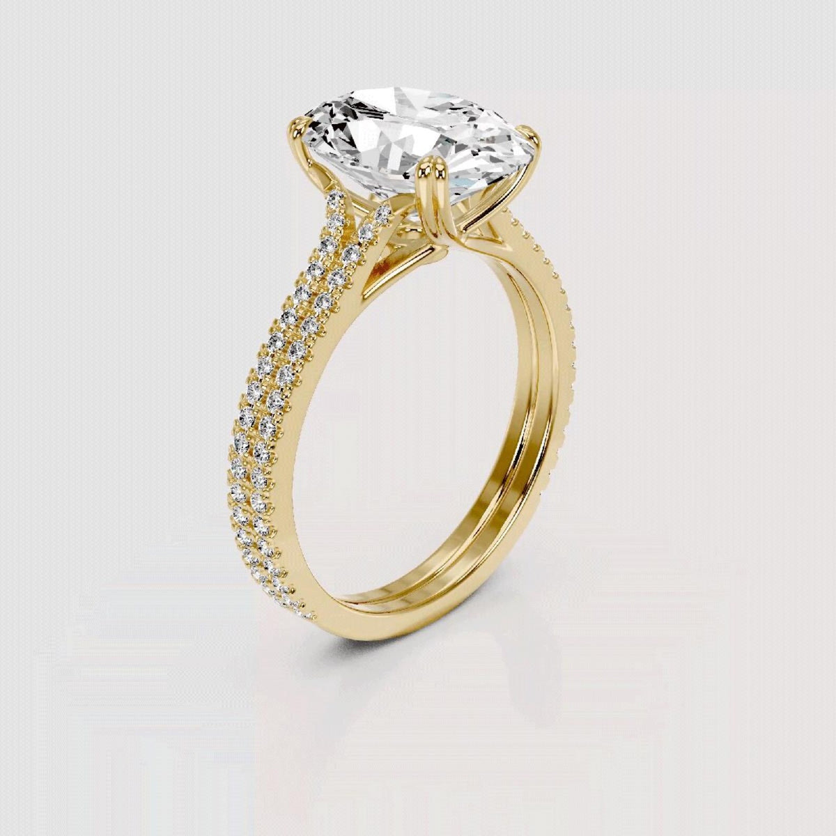 A yellow gold engagement ring featuring a large cushion-cut clear center stone and a pavé-set diamond band, shown on a light gray background.