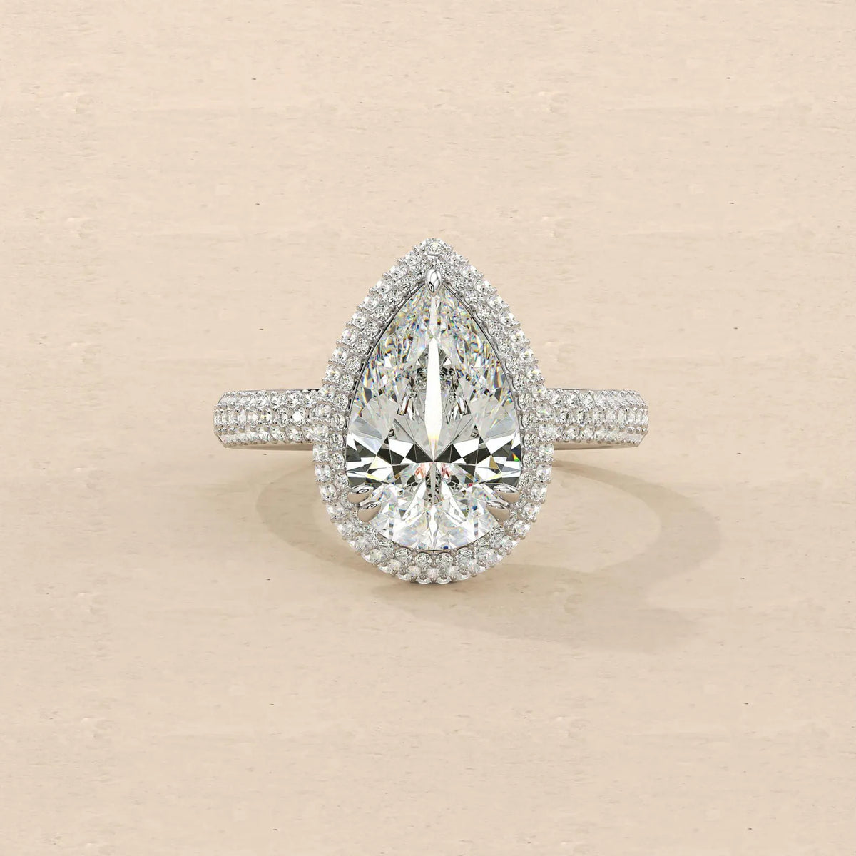 Top-down view of 4 Carat Pear Cut Lab Grown Diamond Engagement Ring with double halo and multi-row pave band in white gold