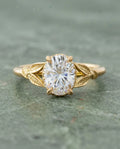 Top-down view of 2 Carat Oval Cut Lab Grown Diamond Engagement Ring with engraved leaf shoulders in yellow gold