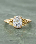 Top-down view of 2 Carat Oval Cut Lab Grown Diamond Engagement Ring with engraved leaf shoulders in yellow gold