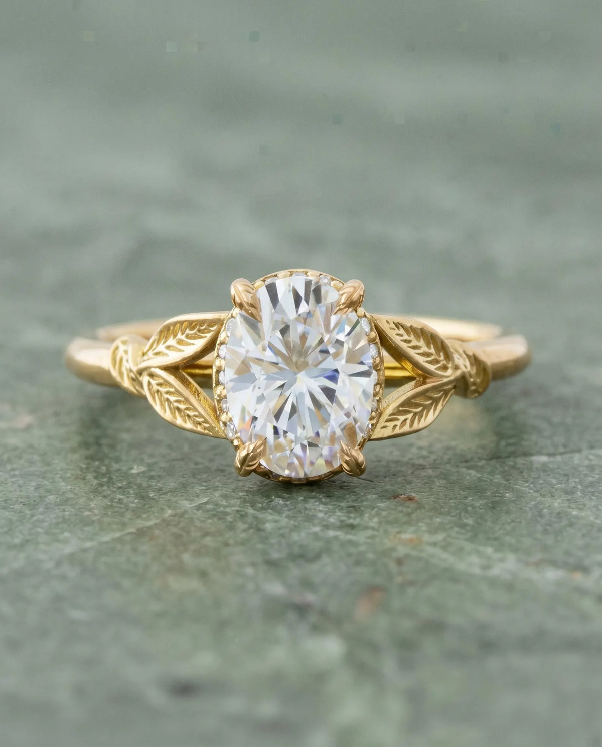 Top-down view of 2 Carat Oval Cut Lab Grown Diamond Engagement Ring with engraved leaf shoulders in yellow gold