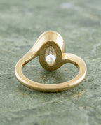 Rear gallery view showing the smooth full bezel frame and interior curved band of 3 Carat Oval Lab Diamond Ring in yellow gold