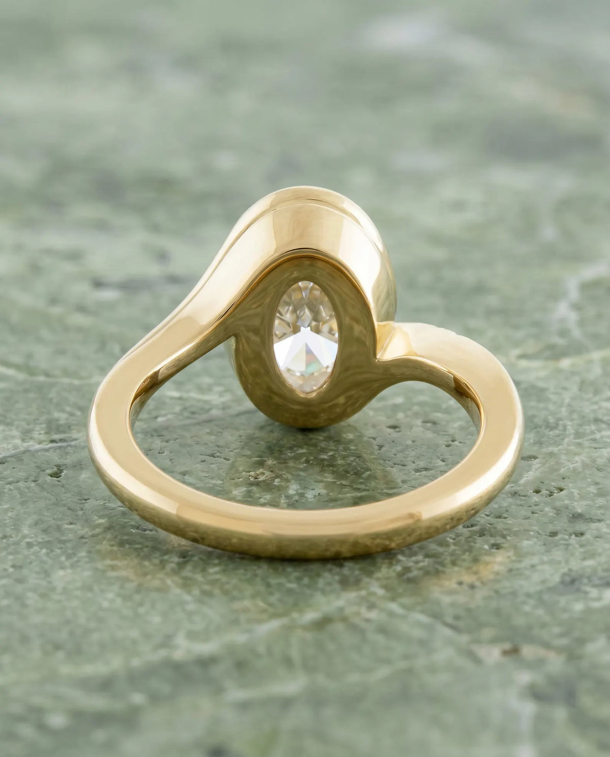 Rear gallery view showing the smooth full bezel frame and interior curved band of 3 Carat Oval Lab Diamond Ring in yellow gold