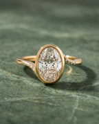 Top-down view of 3 Carat Oval Cut Lab Grown Diamond Engagement Ring with full bezel setting and flush-set accent diamonds on bypass band