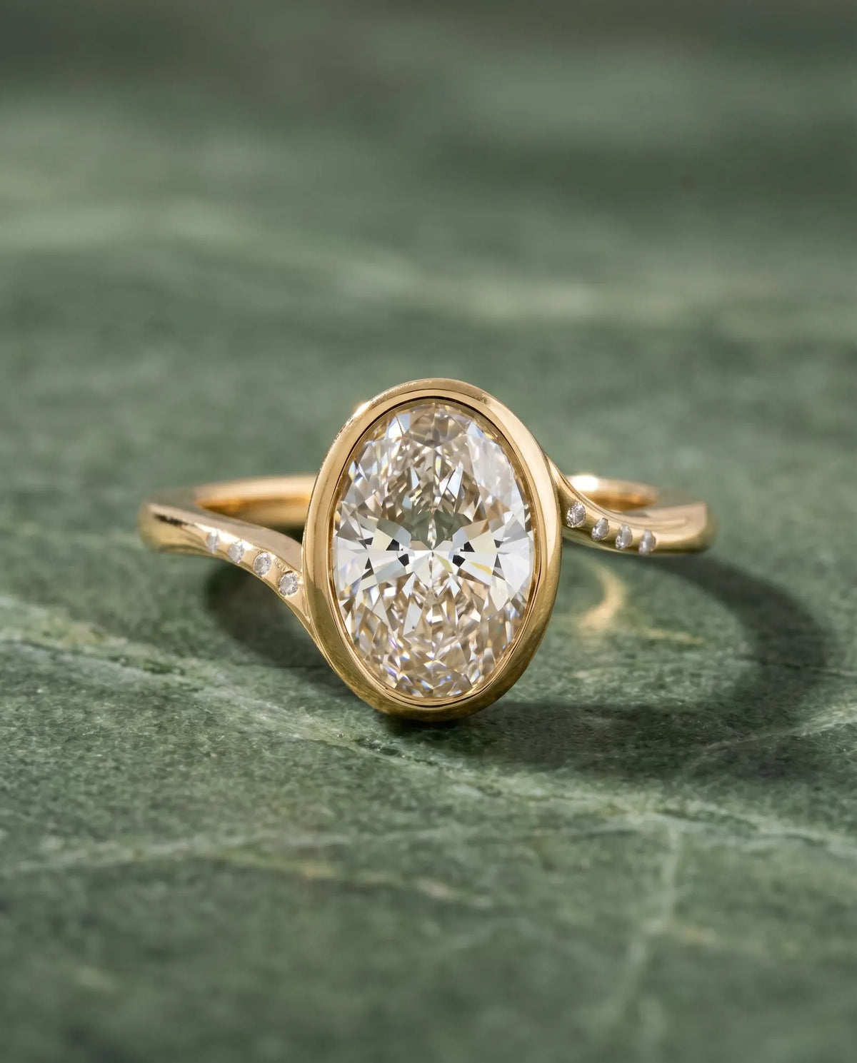 Top-down view of 3 Carat Oval Cut Lab Grown Diamond Engagement Ring with full bezel setting and flush-set accent diamonds on bypass band