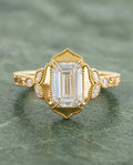 Top-down view of 3 Carat Emerald Cut Lab Grown Diamond Vintage Engagement Ring with pointed milgrain halo frame and engraved yellow gold band