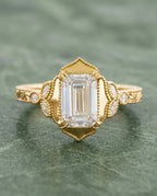 Top-down view of 3 Carat Emerald Cut Lab Grown Diamond Vintage Engagement Ring with pointed milgrain halo frame and engraved yellow gold band