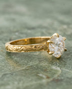 Side angled view of 3 Carat Round Cut Lab Grown Diamond Solitaire Ring with 6 prongs and hand-engraved scrollwork band in yellow gold
