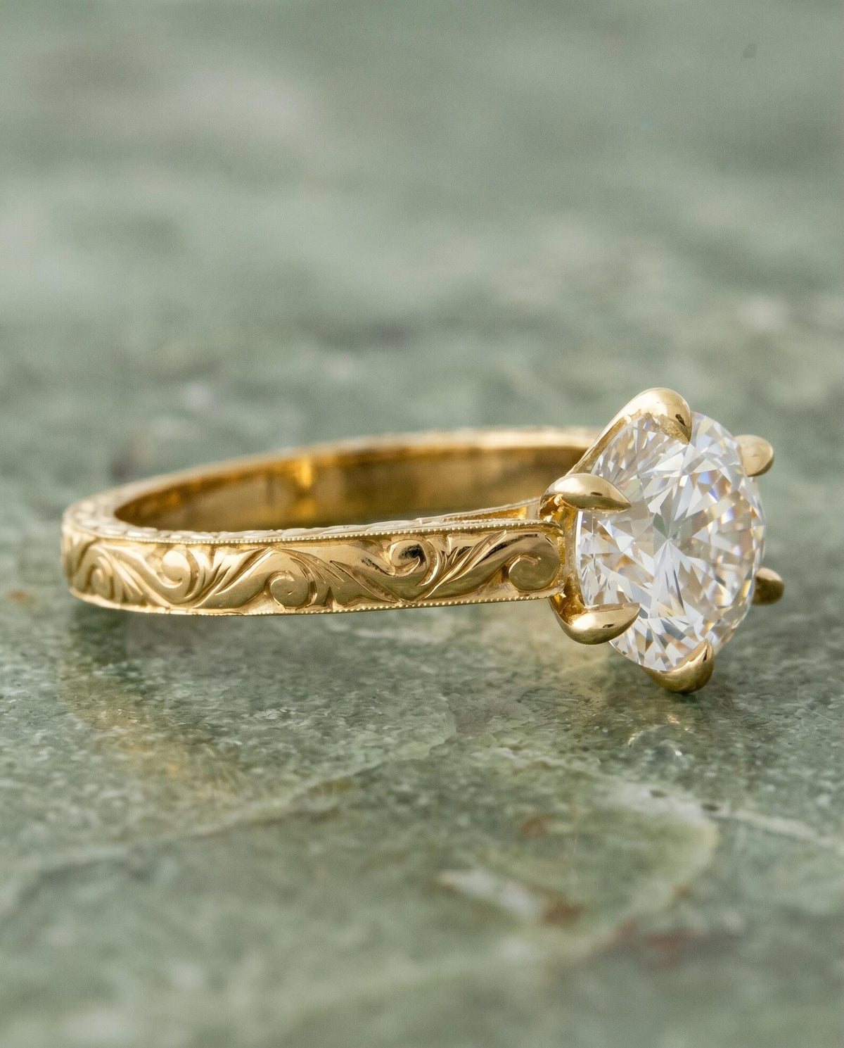Side angled view of 3 Carat Round Cut Lab Grown Diamond Solitaire Ring with 6 prongs and hand-engraved scrollwork band in yellow gold