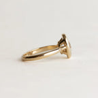 Close-up side view of 2 Carat Oval Lab Diamond Ring showing starburst-set diamond detail on the yellow gold band