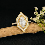 2 Carat Marquise Cut Lab Grown Diamond Ring with geometric pave halo and milgrain detail on gold band resting on wood branch
