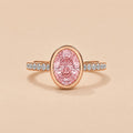 Top-down front view of 2 Carat Pink Oval Cut Lab Grown Diamond Bezel Ring with pave diamond band