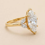 Side view of 4 Carat Marquise Cut Lab Grown Diamond Ring with marquise leaf accent stones on a yellow gold band