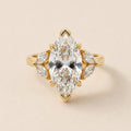Top-down studio view of 4 Carat Marquise Cut Lab Grown Diamond Ring with marquise leaf side stone clusters in yellow gold