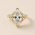 Top-down studio view of 4 Carat Marquise Cut Lab Grown Diamond Ring with marquise leaf side stone clusters in yellow gold