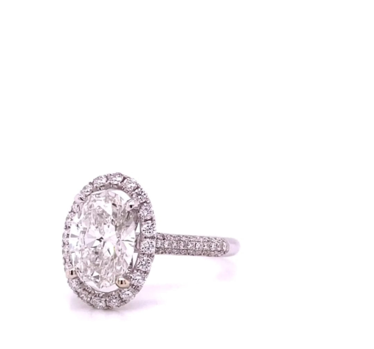 Side profile showing the elevated basket setting and pave band detail of a 4 carat oval lab grown diamond engagement ring.